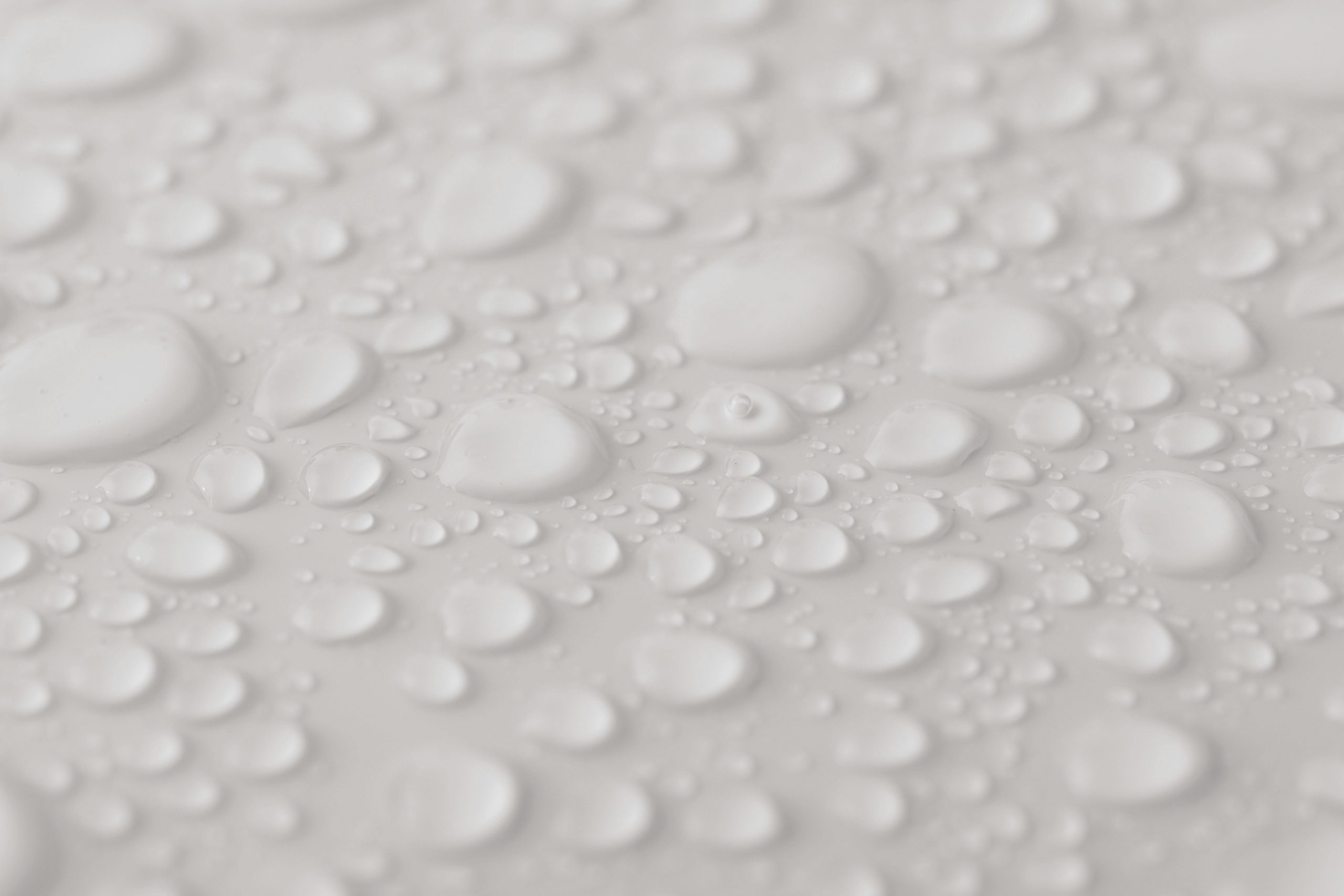 water drops on white surface