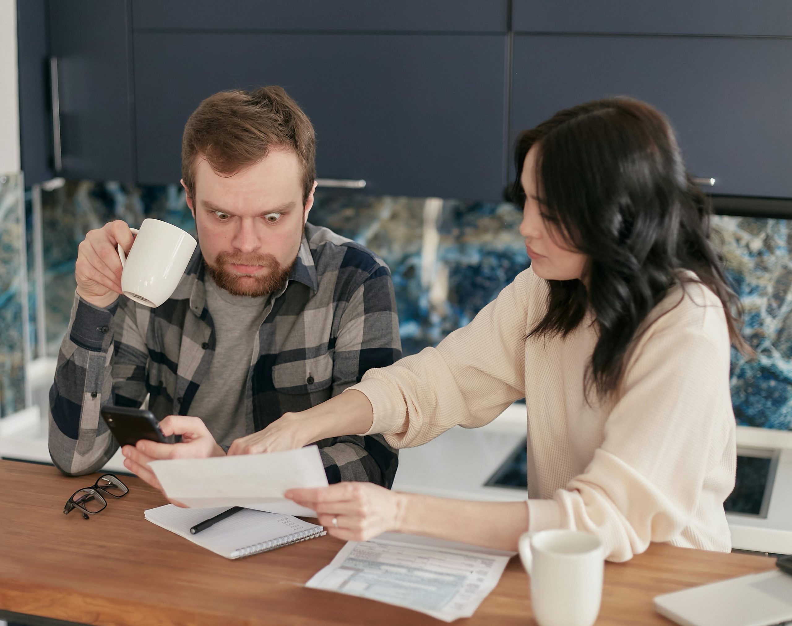 couple reacting with shock to a high energy bill